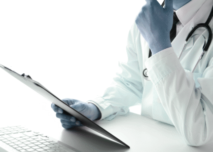 Doctor wearing a white coat and stethoscope, holding a clipboard